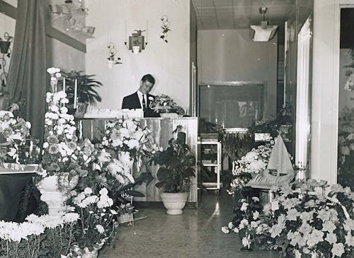 A member of the McNamara staff, waiting to help at the customer service desk, circa 1950
