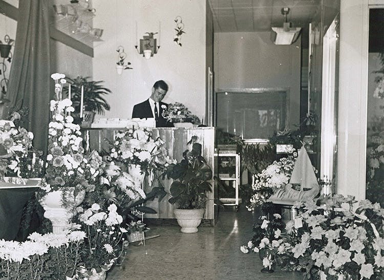 A member of the McNamara staff, waiting to help at the customer service desk, circa 1950